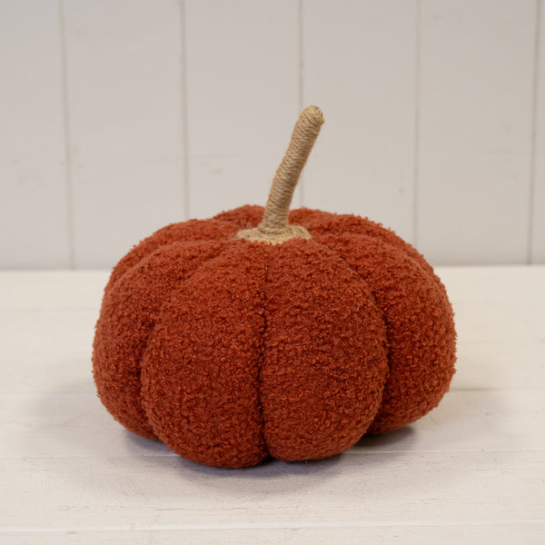 Large orange boucle pumpkin ornament with segmented shape and fabric stalk