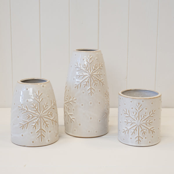 Three white snowflake vases and pot pictured together
