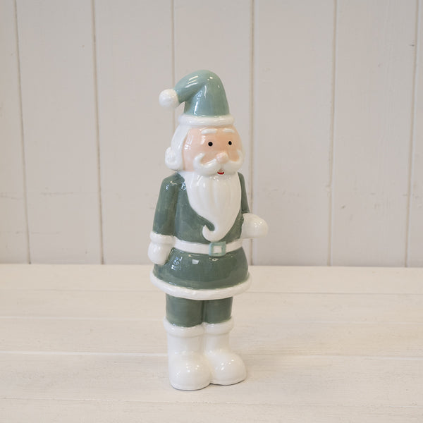 Standing Santa ornament in a green outfit and hat