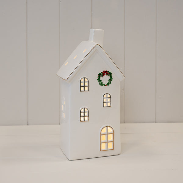 Large white LED house with a wreath on its front