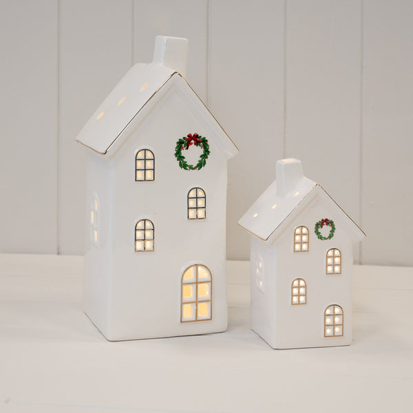 Large and small white wreath-front LED houses shown illuminated together