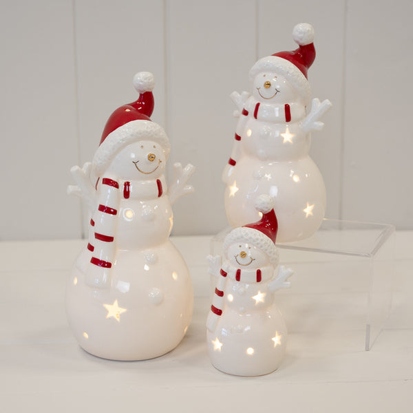 Three illuminated snowman decorations in different sizes pictured together