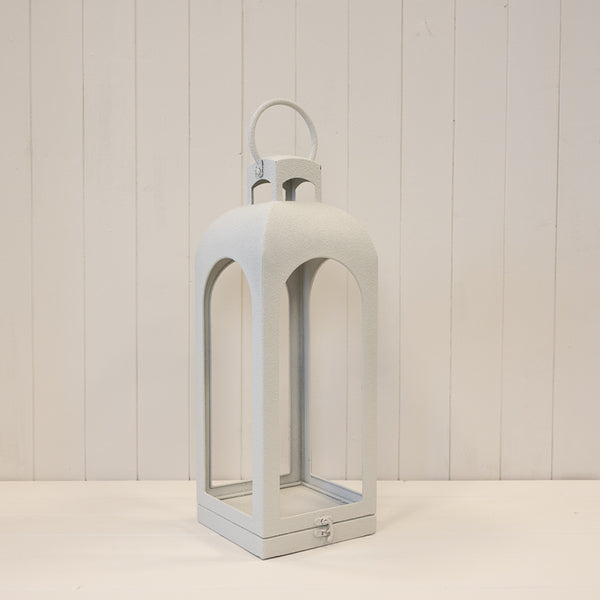 Medium off-white open-faced metal lantern with arched sides and a loop handle
