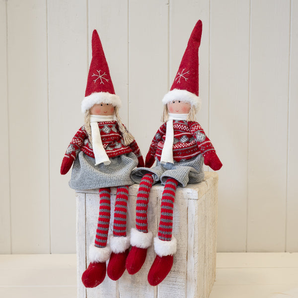 Red and grey fabric boy and girl winter figures displayed together