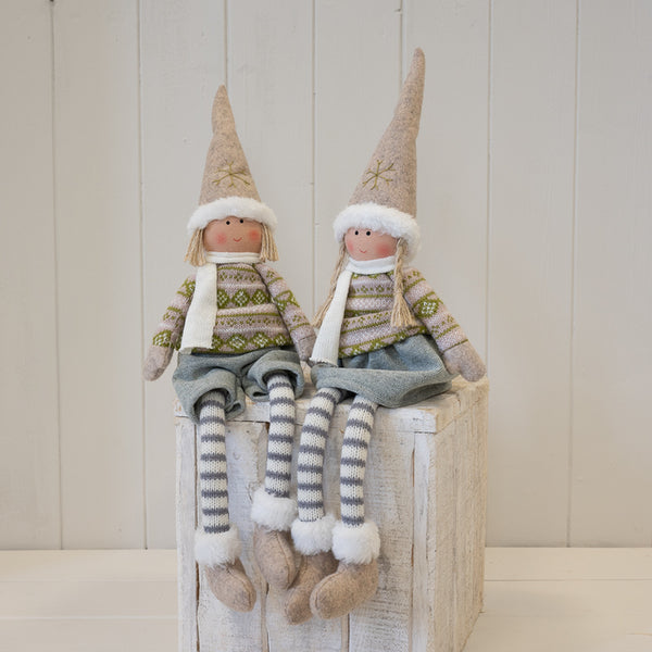 Natural and grey fabric boy and girl winter figures displayed together