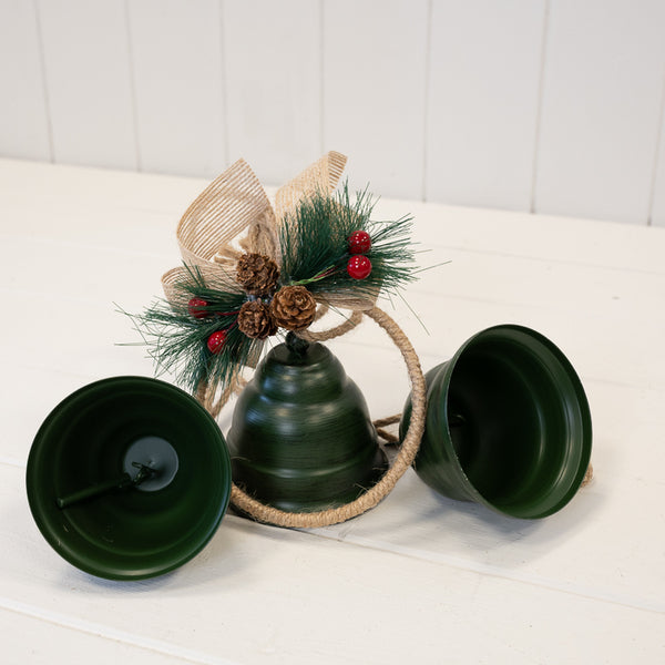 Close-up of three green bells with hoop, ribbon and pinecone detail